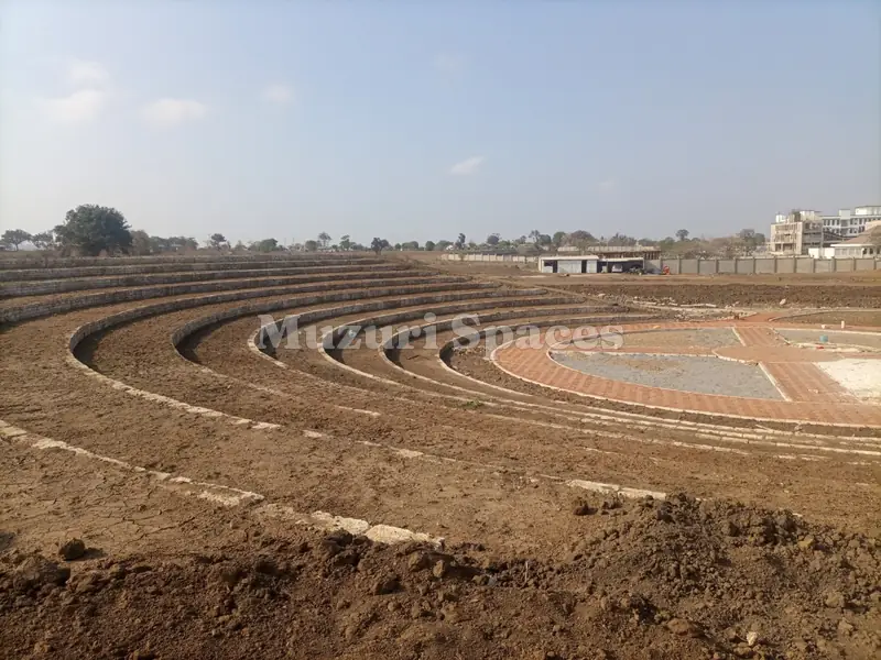 Before: Kilifi park amphitheatre during earthworks: bare terraced soil around the paved stage